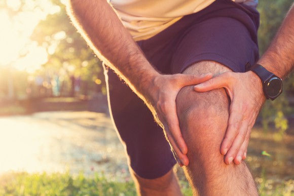 A person rubbing his knee