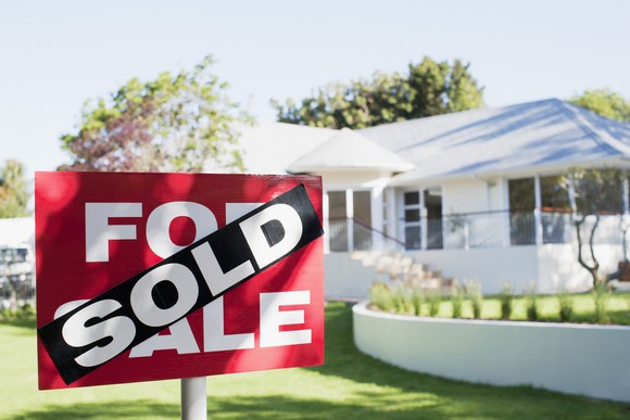 House with a "sold" sign.
