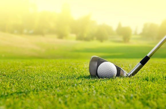 Golf club addressing a ball on the fairway.