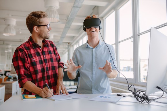 Two men test out a virtual-reality headset.