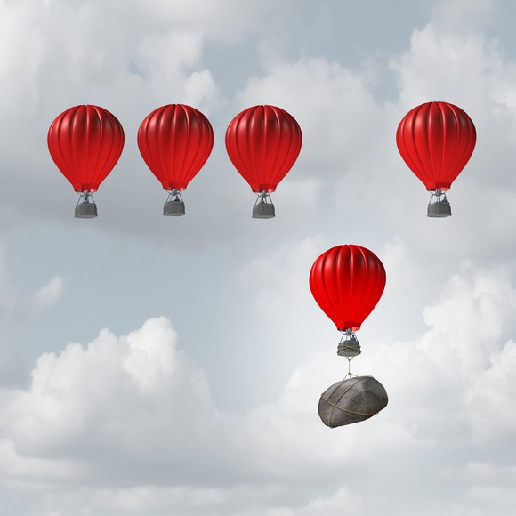 One out of five hot-air balloons is being weighed down by a boulder.