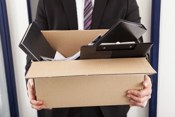 man holding box of work stuff