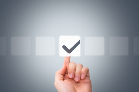 Male hand touching a button and ticking a check box.
