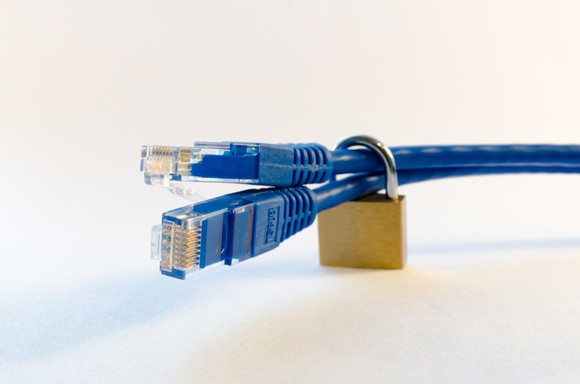 Data security concept, padlock around Ethernet cables.