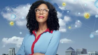 A woman wearing glasses looking up at blue skies with yellow planets.