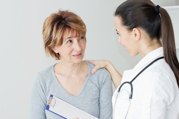 A doctor having a discussion with a female patient. 