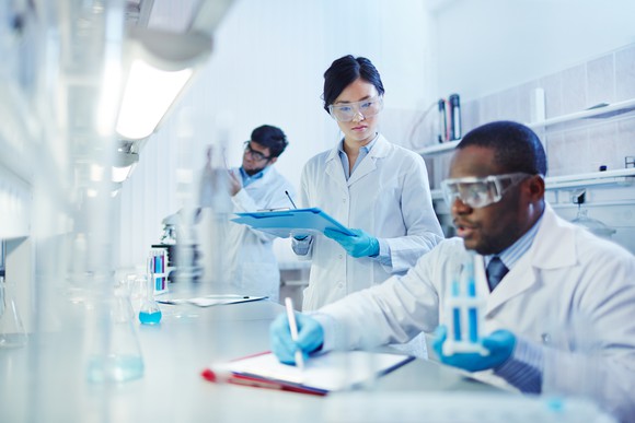 Three technicians in a biotechnology lab.