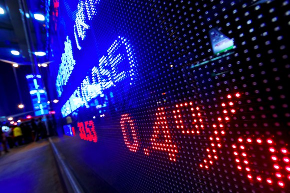 Wall Street electronic trading board at night.