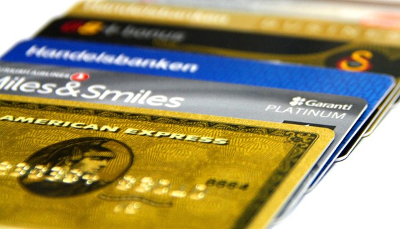 Stack of credit cards with American Express Gold card on top.