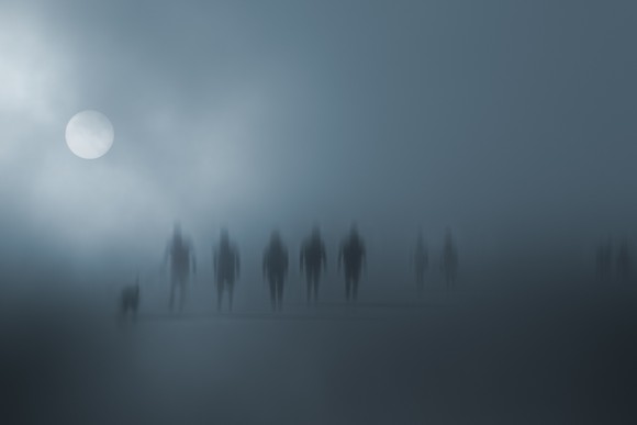 Mysterious blurred people walking in the fog.