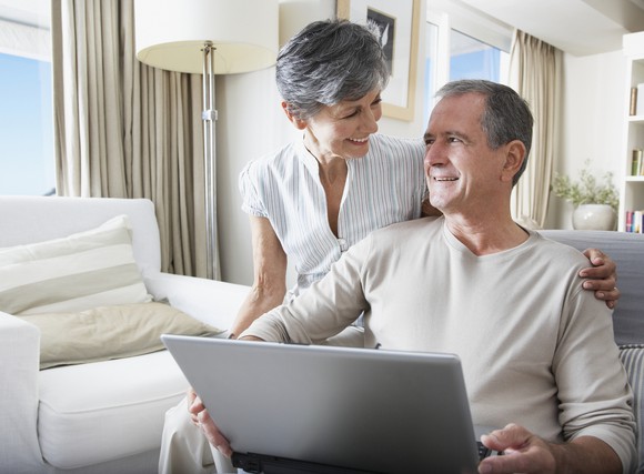 Senior couple looking at laptop