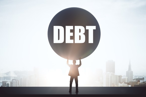 Person holding up a ball of debt