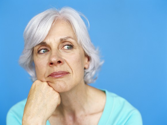 A senior woman lost in thought.