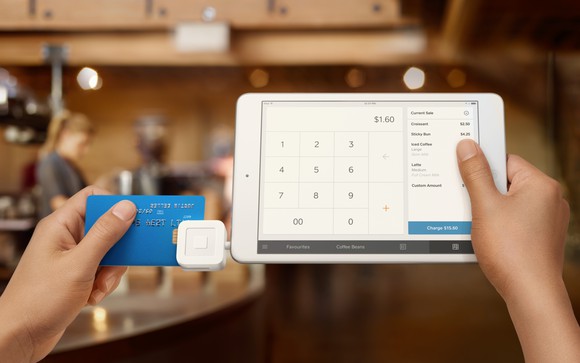 Merchant using a Square device to accept payment from a credit card.