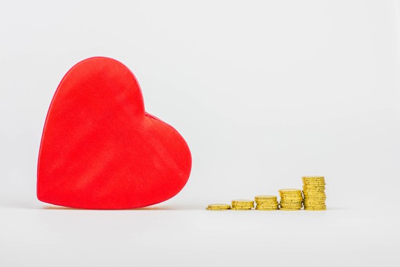 A heart next to coins.