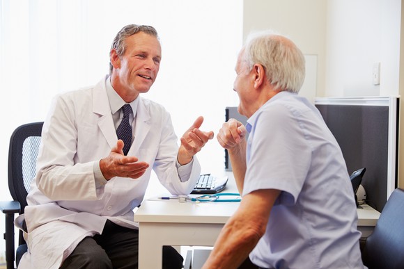Male patient talking with doctor.