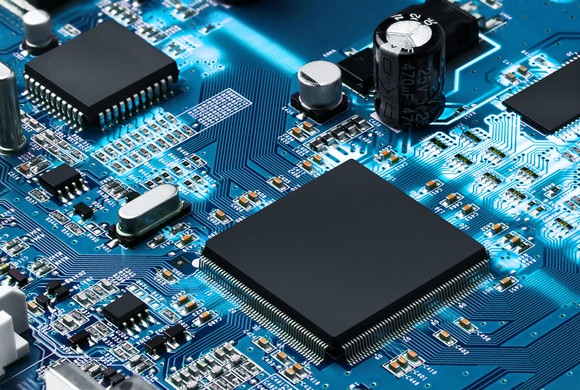 A circuit board shows several different types of semiconductors soldered to a motherboard