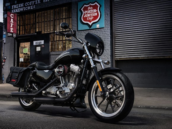 A black Harley-Davidson Sportster XL 883 parked streetside.