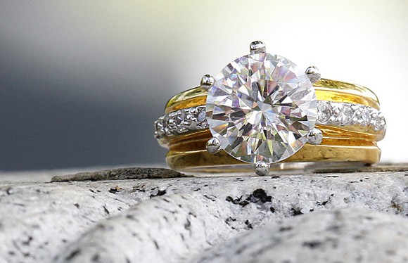 Diamond ring sitting on a granite counter.