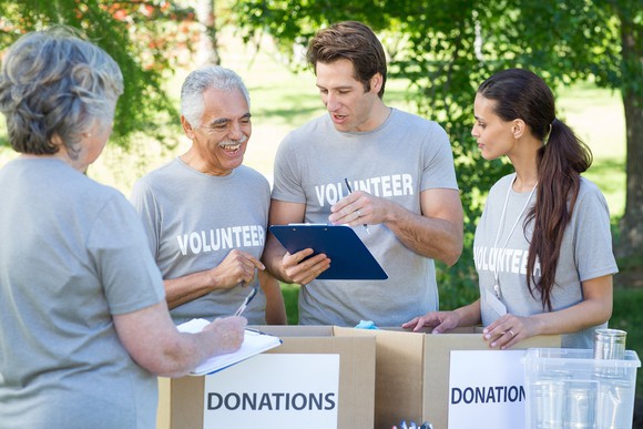 Group of volunteers collecting donated goods for a charity.