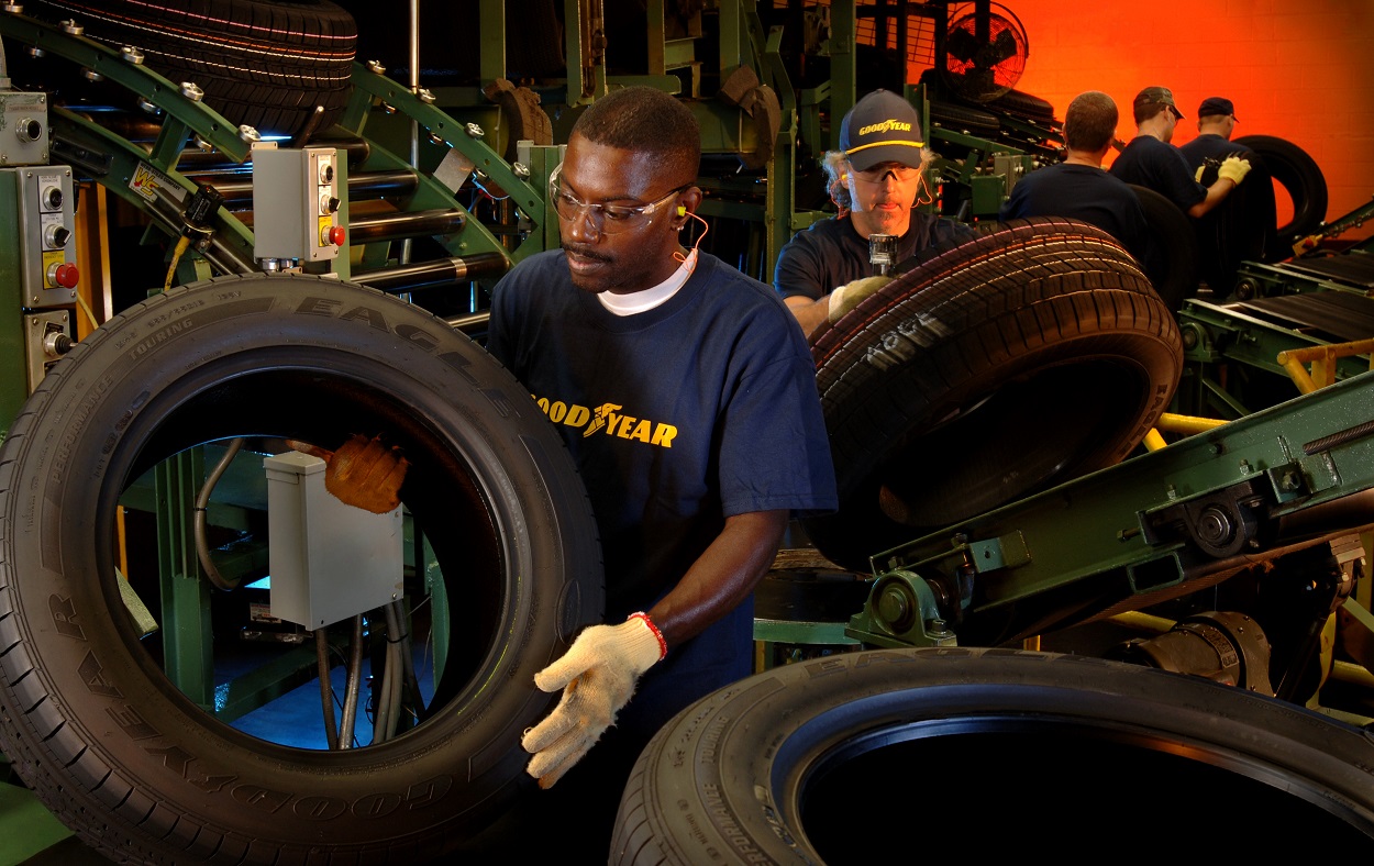 Goodyear workers with tires.