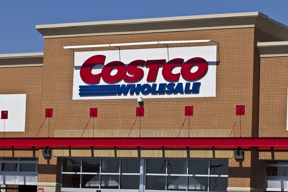 Costco Wholesale sign at the top of a brick building facade.