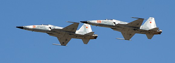 Two F-5 Tiger II aircraft's flying.