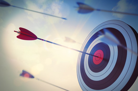 a bullseye target with an arrow embedded in it a bullseye target with an arrow embedded in it