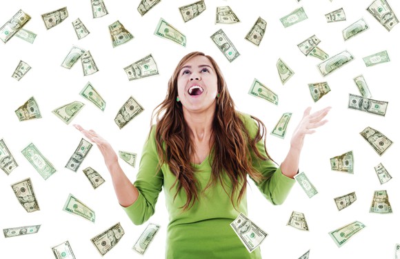 Young woman surrounded by cash falling from above.