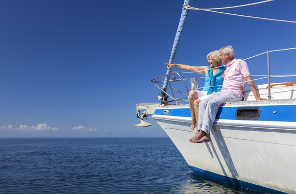 Senior couple sitting on sailboat