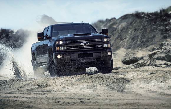 A Chevy Silverado 2500 HD driving on a dirt road.