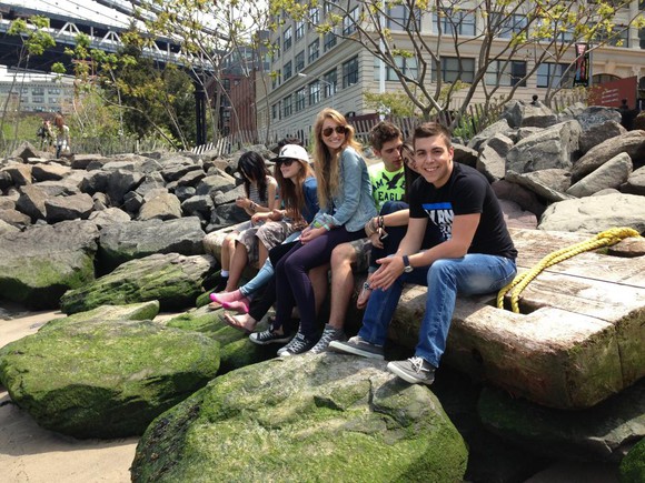 Teens sitting on rocks