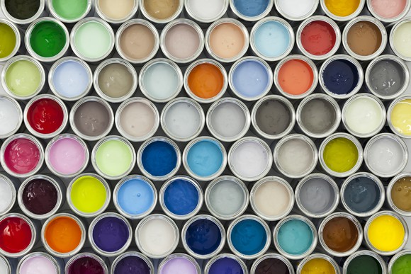 A selection of open paint cans viewed from directly above.