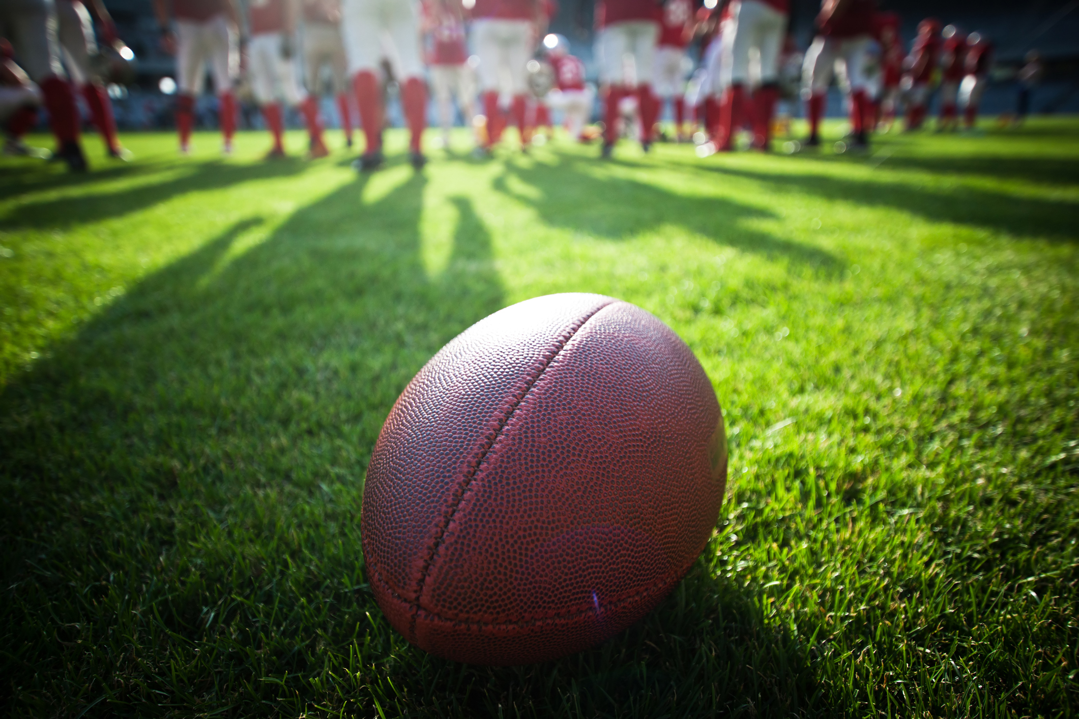 A football with players in the background