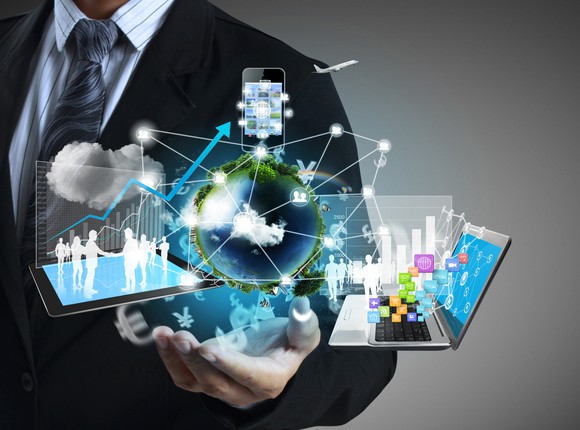 Man in suit with images of a flurry of cloud computing concepts in his hand.