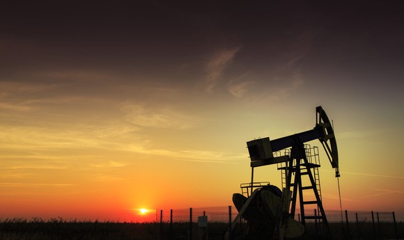 Drilling rig with setting sun in the background.
