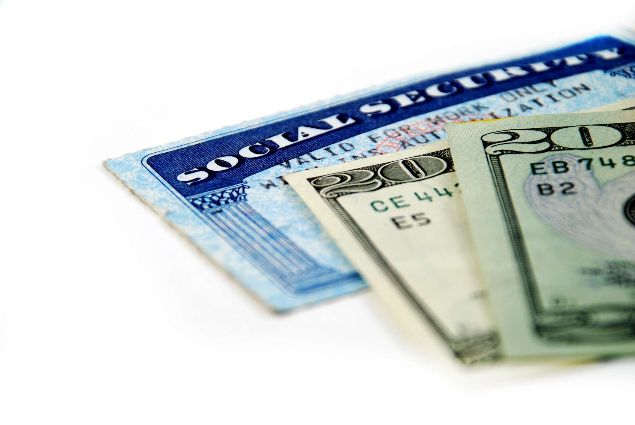 Social Security card with money on top of it.