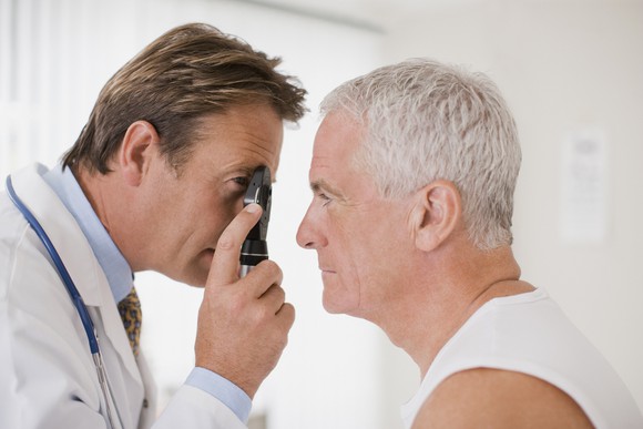 A doctor examines a patient's eye.