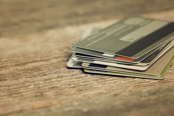 Multiple credit cards stacked on a table.