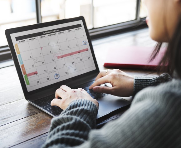 Woman working on calendar on laptop