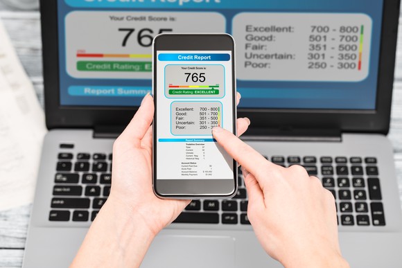Credit report on a smart phone and laptop.