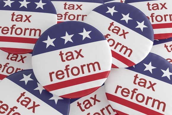 Buttons with "tax reform" and political design.
