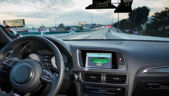The unattended steering wheel and dashboard of an Audi SUV on a highway near Las Vegas.