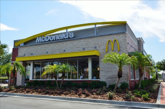 The palm tree-flanked exterior of a McDonald's in Sun City, Florida.