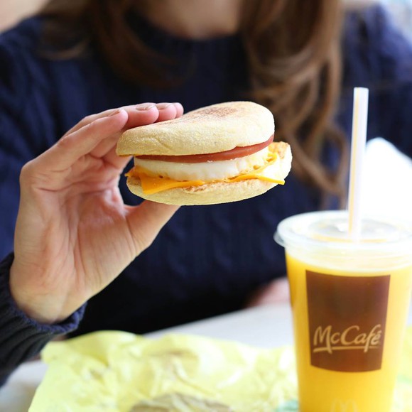 A customer enjoying a breakfast sandwich.