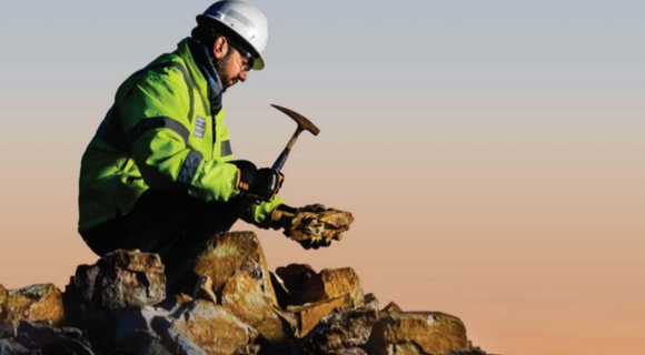 Teck employee hitting a rock.