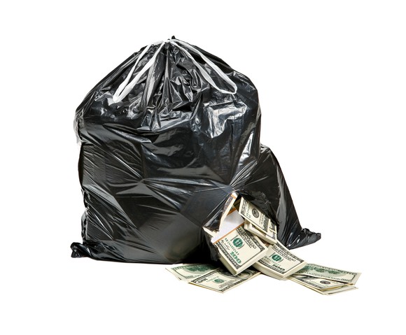 Money spilling out of a trash bag