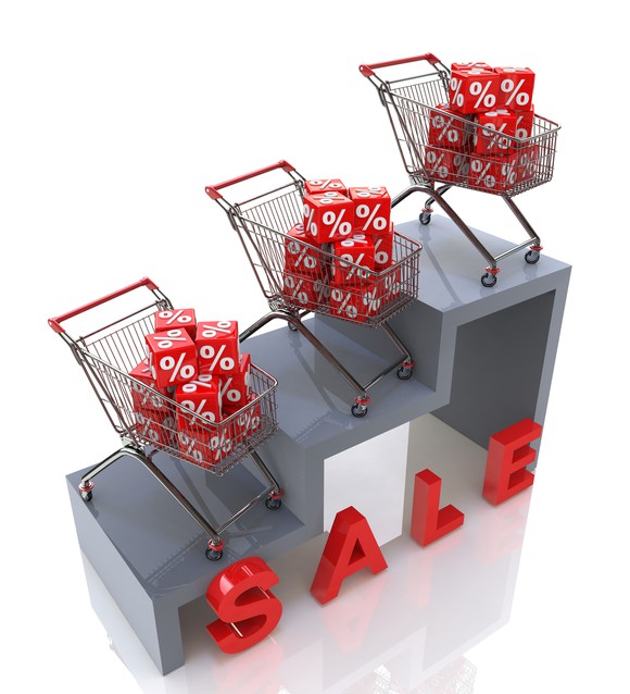 Shopping carts on steps with "SALE" sign below