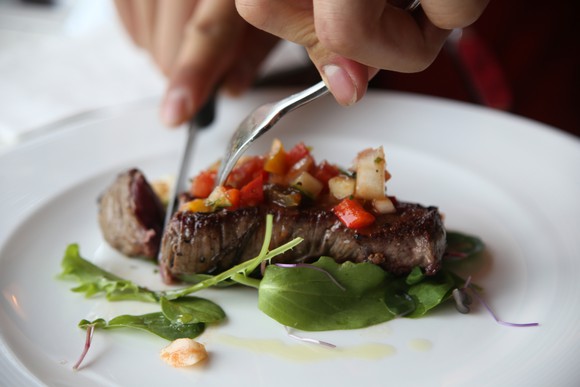 Eating a steak with salad.