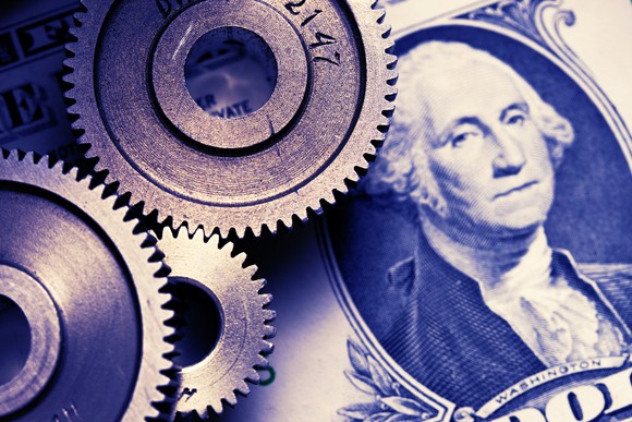 A collage with gears and a one dollar bill